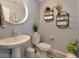 Stylish powder room with pedestal sink and modern decor at 2844 Copper Wind Ln # 4, Las Vegas, NV 89183