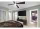 Elegant bedroom with ensuite bathroom access and large TV at 2844 Copper Wind Ln # 4, Las Vegas, NV 89183