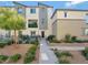 Modern three-story townhome with landscaped front yard and walkway at 2844 Copper Wind Ln # 4, Las Vegas, NV 89183