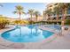 Relaxing pool and spa area with palm trees and building views at 29 Montelago Blvd # 317, Henderson, NV 89011