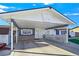 Carport and home entrance with stone accents and white fence at 3169 Nottingham Dr, Las Vegas, NV 89121