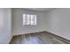 Simple bedroom with wood-look floors and large window at 3318 N Decatur Blvd # 2138, Las Vegas, NV 89130