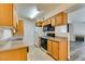 Kitchen with wood cabinets, granite counters, and appliances at 3318 N Decatur Blvd # 2138, Las Vegas, NV 89130