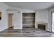 Living room with fireplace, wood-look accent wall, and laminate flooring at 3318 N Decatur Blvd # 2138, Las Vegas, NV 89130