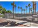 Community pool with surrounding fence and palm trees at 3318 N Decatur Blvd # 2138, Las Vegas, NV 89130