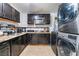 Dark wood cabinets, granite countertops, and stainless steel appliances in this kitchen at 35 Jade Cir, Las Vegas, NV 89106