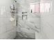 Clean shower with marble tile and built-in shelves at 35 Jade Cir, Las Vegas, NV 89106