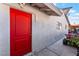 Red door and light gray stucco exterior wall at 35 Jade Cir, Las Vegas, NV 89106