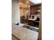 Galley kitchen featuring a double basin sink, granite countertops, and a view into the dining area at 3550 Bay Sands Dr # 2062, Laughlin, NV 89029