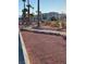 Walking path surrounded by rocks, small shrubs, and palm trees with a building in the background at 3550 Bay Sands Dr # 2062, Laughlin, NV 89029