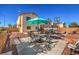 Nice backyard with patio furniture and a teal umbrella at 3592 Gloucester Gate St, Las Vegas, NV 89122