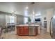 Open kitchen with island, stainless steel appliances, and view to living room at 3592 Gloucester Gate St, Las Vegas, NV 89122