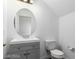 Simple bathroom with gray vanity and round mirror at 3728 Shallow Dove Ct, North Las Vegas, NV 89032