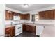 Well-equipped kitchen with dark wood cabinets and white appliances at 3728 Shallow Dove Ct, North Las Vegas, NV 89032