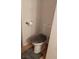 Small bathroom with toilet, wood floor, and gray rug at 4031 Gold Coast Dr, Las Vegas, NV 89121