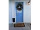 Light blue front door accented with a holiday wreath at 4031 Gold Coast Dr, Las Vegas, NV 89121