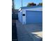 Attached garage with light blue roll-up door and driveway at 4031 Gold Coast Dr, Las Vegas, NV 89121