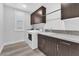 Laundry room with dark brown cabinets, white washer and dryer at 4308 Sunrise Flats St, Las Vegas, NV 89135