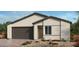 Single-story home with a two-car garage and neutral color scheme at 4400 E Brusca Way, Pahrump, NV 89061