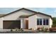 Single-story home with brown garage door and light-colored exterior at 4420 E Brusca Way, Pahrump, NV 89061