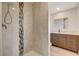 Updated bathroom with shower, vanity, and tiled accents at 4457 Dennis Way, Las Vegas, NV 89121