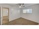 Bedroom with neutral carpet, fan, window, and white walls at 4457 Dennis Way, Las Vegas, NV 89121