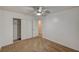 This bedroom features neutral carpet, a ceiling fan, and a closet for storage at 4457 Dennis Way, Las Vegas, NV 89121