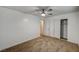 This bedroom features neutral carpet, a ceiling fan, and a closet for storage at 4457 Dennis Way, Las Vegas, NV 89121