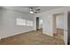 Bedroom with carpet, white walls, fan and view into closet at 4457 Dennis Way, Las Vegas, NV 89121