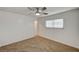 Bedroom with neutral carpet and white walls, featuring a ceiling fan at 4457 Dennis Way, Las Vegas, NV 89121