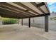 This large carport is covered with a wooden beam structure and a concrete floor at 4457 Dennis Way, Las Vegas, NV 89121