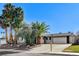 Single-story home with attached two-car garage, landscaping, and palm trees at 4457 Dennis Way, Las Vegas, NV 89121