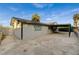 This home features a carport, a concrete patio, and desert landscaping at 4457 Dennis Way, Las Vegas, NV 89121