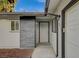 Welcoming front entrance with modern grey stone accents and a crisp white front door at 4457 Dennis Way, Las Vegas, NV 89121