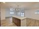 Bright and airy kitchen with a peninsula, wood cabinets, wood floors, and lots of space to entertain at 4457 Dennis Way, Las Vegas, NV 89121