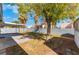 Backyard view showcasing covered patio and grassy area at 4850 Aveneda Grande, Las Vegas, NV 89121