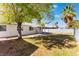 Landscaped backyard with covered patio and mature trees at 4850 Aveneda Grande, Las Vegas, NV 89121