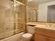 Bathroom with a shower/tub combo and gold fixtures at 4974 Crooked Stick Way, Las Vegas, NV 89113