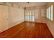 Well-lit bedroom featuring hardwood floors and built-in shelving at 4974 Crooked Stick Way, Las Vegas, NV 89113