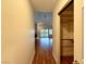 Bright hallway with wood floors and views to living room and closet at 4974 Crooked Stick Way, Las Vegas, NV 89113