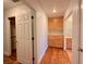 Clean hallway with wood floors, linen closet and bathroom access at 4974 Crooked Stick Way, Las Vegas, NV 89113