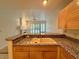 Kitchen features a double sink and granite countertops at 4974 Crooked Stick Way, Las Vegas, NV 89113