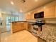 Kitchen with wood cabinets and granite countertops at 4974 Crooked Stick Way, Las Vegas, NV 89113