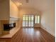 Living room with hardwood floors, fireplace and sliding doors to patio at 4974 Crooked Stick Way, Las Vegas, NV 89113