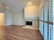 Living room with hardwood floors, fireplace and large windows at 4974 Crooked Stick Way, Las Vegas, NV 89113