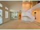 High-ceilinged living room, staircase, and mirrored wall at 4974 Crooked Stick Way, Las Vegas, NV 89113