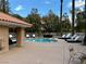 Community pool with lounge chairs and covered seating area at 4974 Crooked Stick Way, Las Vegas, NV 89113