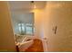 Wooden staircase leading to an open living area with large windows at 4974 Crooked Stick Way, Las Vegas, NV 89113