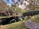 Community pond with lush landscaping and houses reflected in the water at 4974 Crooked Stick Way, Las Vegas, NV 89113