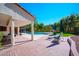 Large backyard features a covered patio, a sparkling pool, and mature landscaping at 56 Sawgrass Ct, Las Vegas, NV 89113